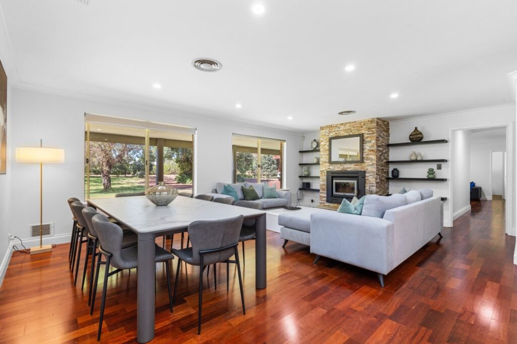 A very spacious living room area, along with a sofa and a dining table.