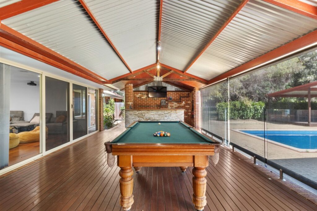 An indoor pool table located in the backyard.