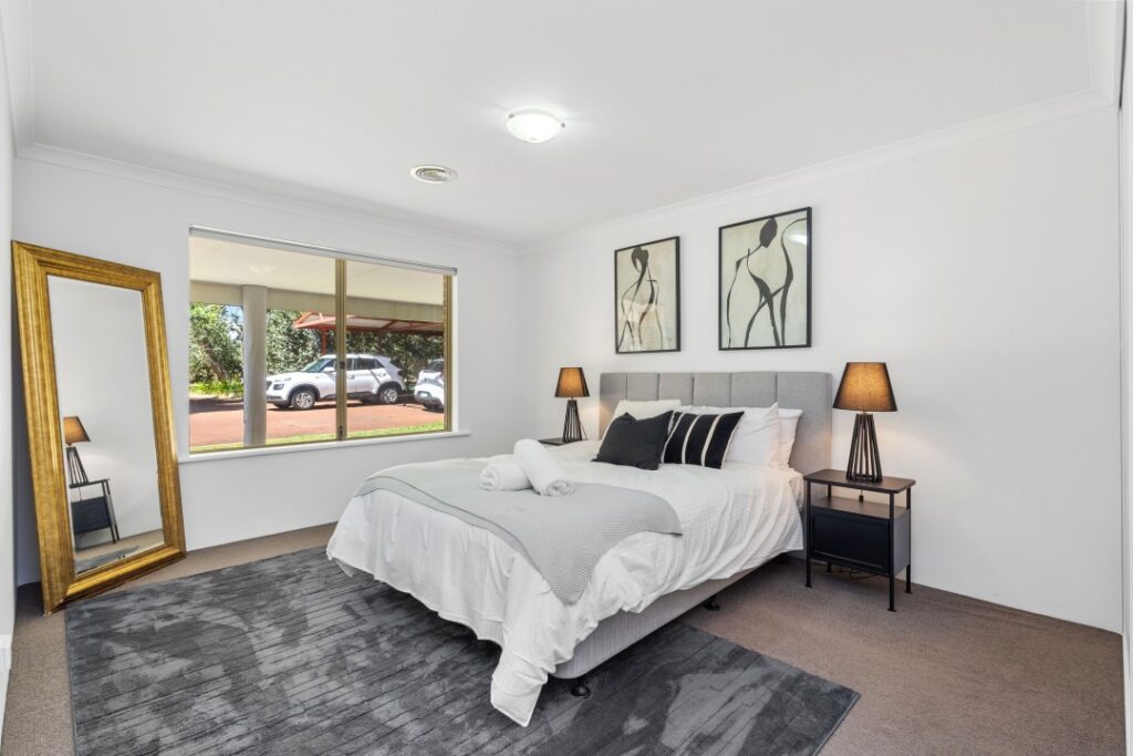 The third bedroom with a standalone full-length mirror.