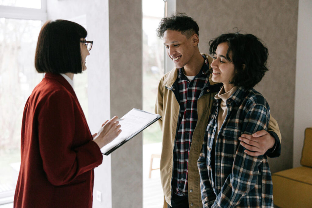Airbnb host explaining house rules to smiling guests.