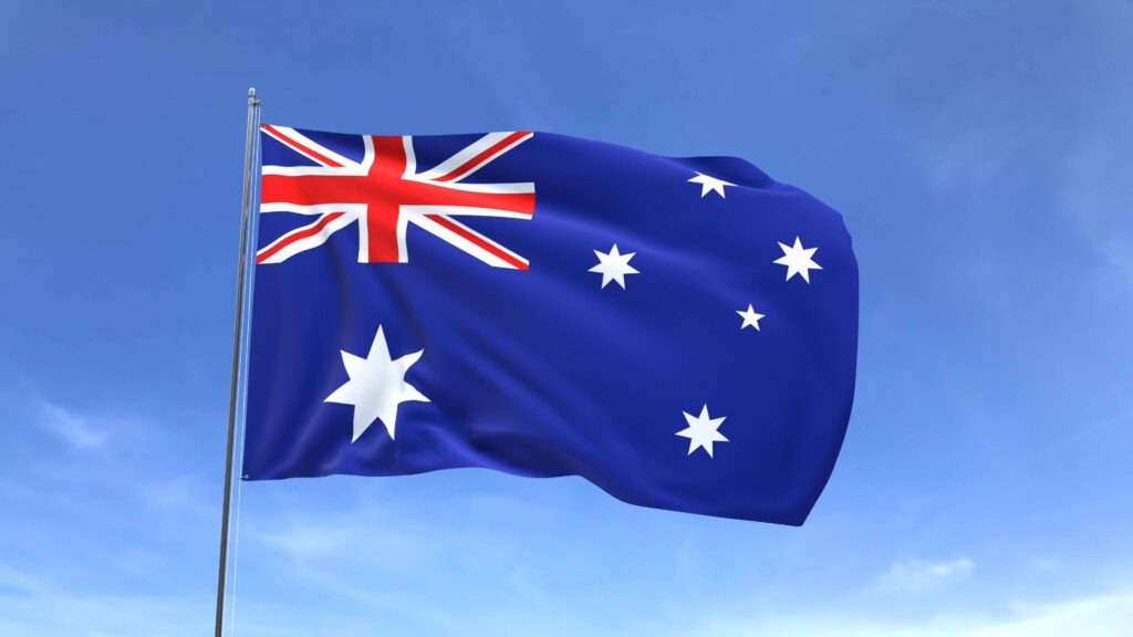 Waving flag of Australia on blue sky background.