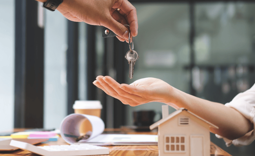 A hand hand over a key to the Sepal Stays property management.