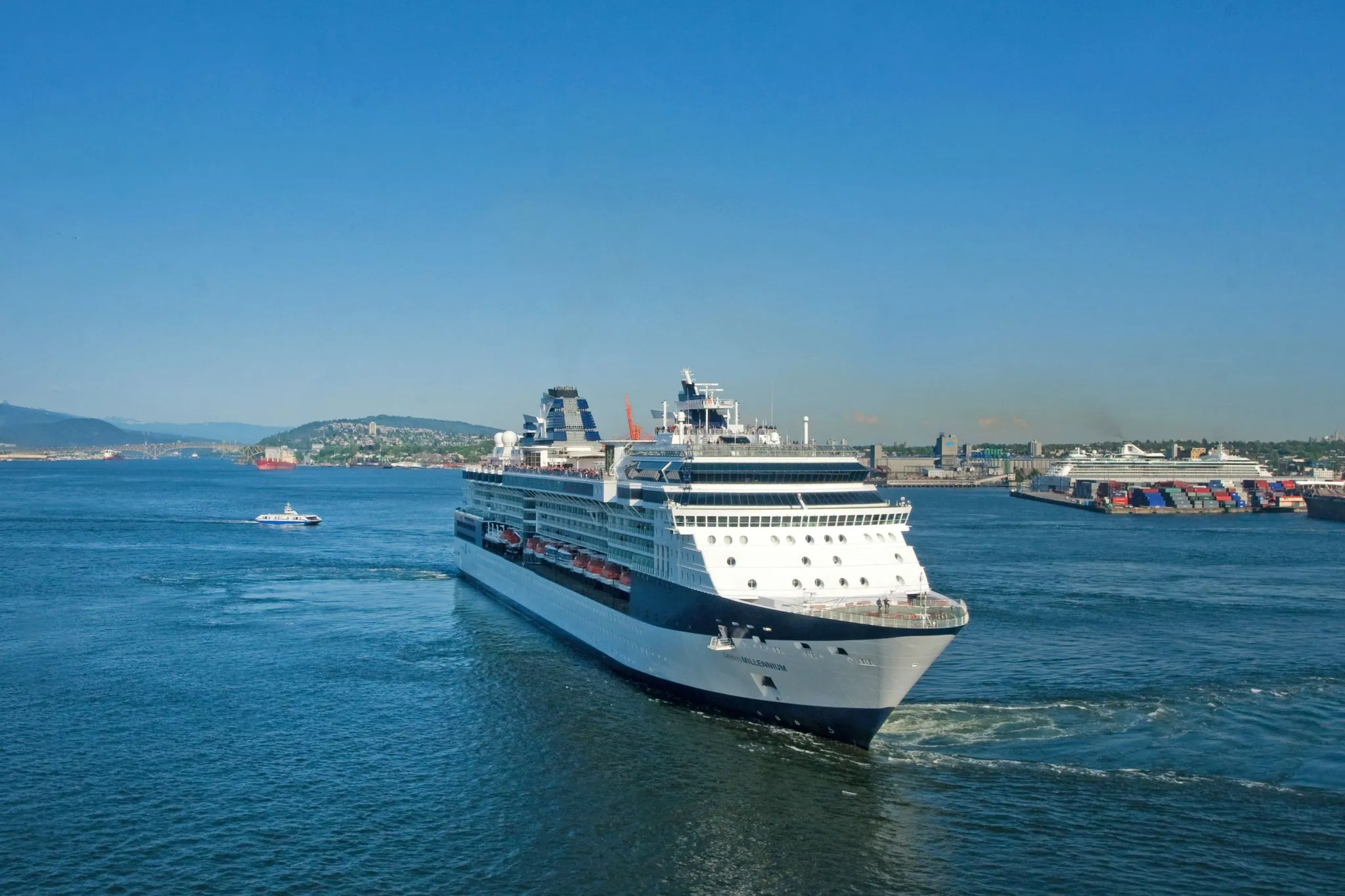 Cruise ship sailing into a harbour on a clear day