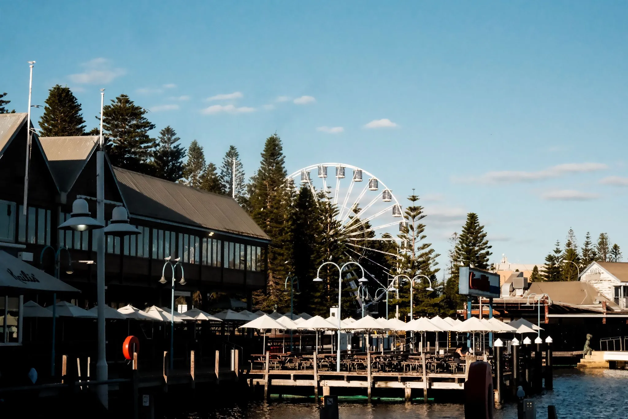 Fremantle waterfront with the Ferris wheel behind the fishing boat harbour restaurants