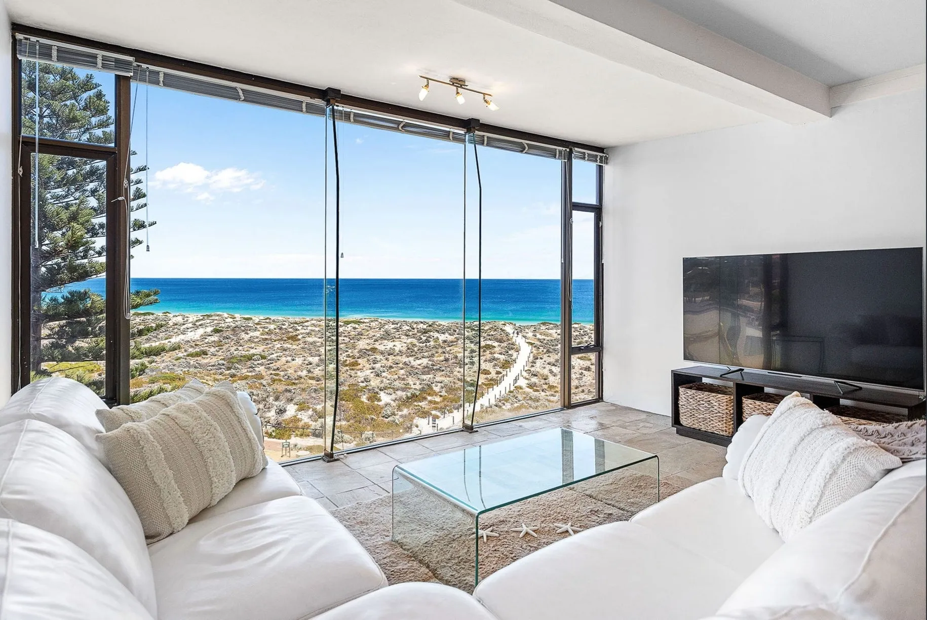 Living room of a Scarborough beachfront apartment with ocean views, managed by Sepal Stays